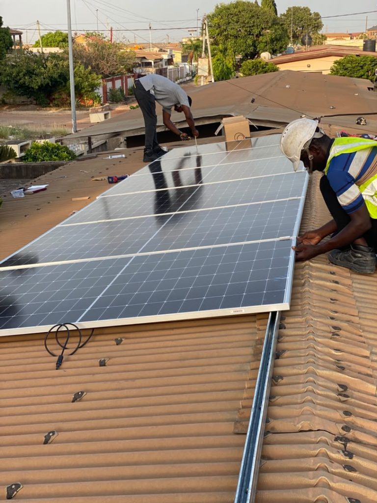Cmerax technicians installing solar panels on a rooftop